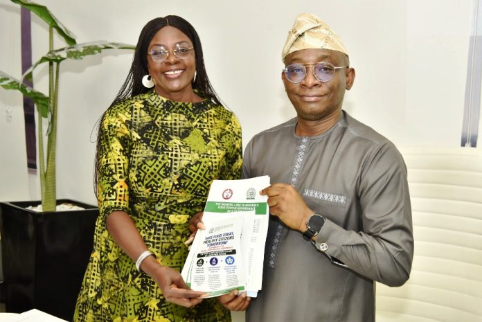 Director-General/CEO, Bureau of Public Procurement (BPP), Dr. Adebowale A. Adedokun, FCIPS, right, being presented with a copy of the Nigerian Council of Food Science and Technology (NiCFoST) document by the Registrar/CEO, Mrs. Veronica Eze during her visit to the BPP in Abuja.