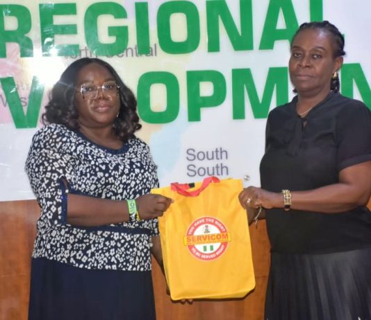 L-R; The Head of SERVICOM Operations, Mrs. Ngozi Akinbodewa presenting awareness materials to the representative of the Permanent Secretary, Dr. Mary Ada Ogbe, the Director of Special Duties, Mrs. Gloria Inyangabasi, on behalf of the Ag. National Coordinator/ CEO of the SERVICOM Office Presidency, during the official inauguration of the Ministerial SERVICOM Unit and Committee (MSU/MSC) held on 17th August, 2026, at the Headquarters of the Ministry of Regional Development (MRD).