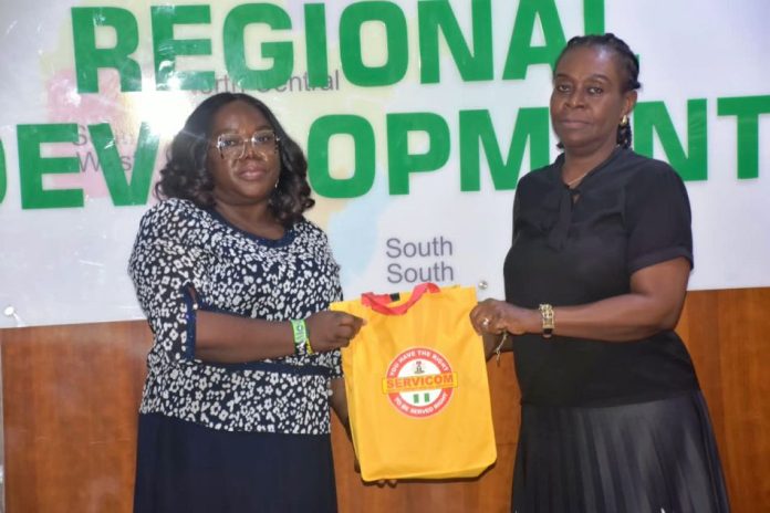 L-R; The Head of SERVICOM Operations, Mrs. Ngozi Akinbodewa presenting awareness materials to the representative of the Permanent Secretary, Dr. Mary Ada Ogbe, the Director of Special Duties, Mrs. Gloria Inyangabasi, on behalf of the Ag. National Coordinator/ CEO of the SERVICOM Office Presidency, during the official inauguration of the Ministerial SERVICOM Unit and Committee (MSU/MSC) held on 17th August, 2026, at the Headquarters of the Ministry of Regional Development (MRD).