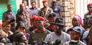 Minister's representatives- Director, Mines Inspectorate, Engr Imam Ganiyu(right), Director, Special Duties, Engr Frank Odom, (middle) and Commander, Mining Marshals, Attah Onoja listening to protester at the Ministry of Solid Minerals Development, Abuja on Thursday