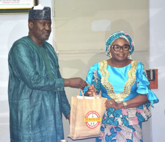 The Ag. National Coordinator/CEO of the SERVICOM Office, Mrs. Helen Lawal presenting some awareness materials to the Permanent Secretary, Federal Ministry of Aviation and Aerospace Development, Mr. Mahmud Adam Kambari FCNA, FICA, during the courtesy visit to the Ministry’s Headquarters in Abuja on 3rd September, 2026.