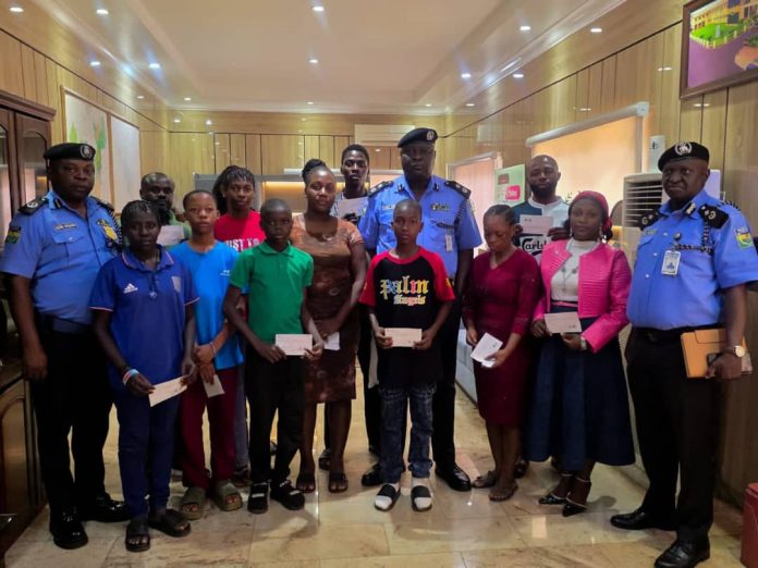CP. Samuel Etaifo Erale psc mnips And Two Of His Mgt. Team In A Group Photograph With Family Members Of The Deceased Officers And Recipients OF The Cheques