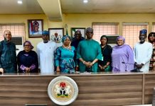Middle: Representative of the RMAFC Chairman, Dr. Ekene Enefe in a group picture with stakeholders during the meeting at RMAFC HQ, Abuja.