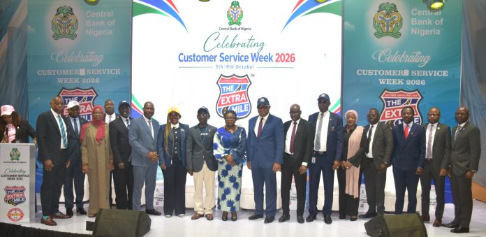 R – L, Director, Risk Management Department CBN, Dr. Blaise Ijebor (8th), Ag. National Coordinator/CEO of the SERVICOM Office, Mrs. Helen Lawal (9th) and Ag. Director, Special Duties CBN, Mr. Ishiaku Polycarp (10th) in a group photograph with other directors and other Management Staff during the celebration of the 2026 Customer Service Week at the bank headquarters in Abuja.