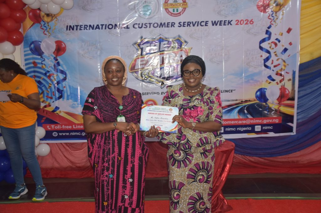 Ag. National Coordinator/CEO of the SERVICOM Office, Mrs. Helen Lawal presenting Heroes of Service Award to one of the awardees during her tour of the 2026 International Customer Service Week at the National Identity Management Commission (NIMC) on 9th October, 2026 in Abuja.