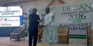(Right) The Permanent Secretary (GSO) Dr. Ibrahim Abubakar Kana mni recieving his Patron of DECAN Award (Plague) from the former Vice President of Sierra Leone, Samuel Sam - Sumana during the Defence Correspondents Association of Nigeria Conference and award ceremony on Monday, 12th October, 2026 in Abuja.