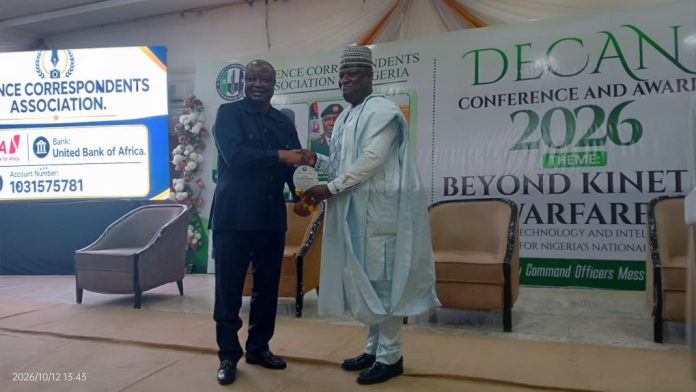 (Right) The Permanent Secretary (GSO) Dr. Ibrahim Abubakar Kana mni recieving his Patron of DECAN Award (Plague) from the former Vice President of Sierra Leone, Samuel Sam - Sumana during the Defence Correspondents Association of Nigeria Conference and award ceremony on Monday, 12th October, 2026 in Abuja.