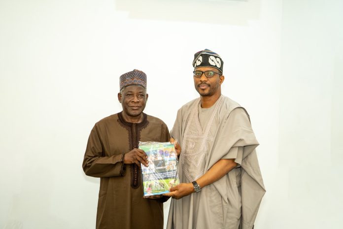 IMG-20261013-WA0021 L-R: The MD/CEO, North-West Development Commission, Prof. Shehu Abdullahi Ma’aji being presented request for partnership documents by the Kano State Commissioner for Rural and Community Development, Dr. Abdulqadir Abdussalam.