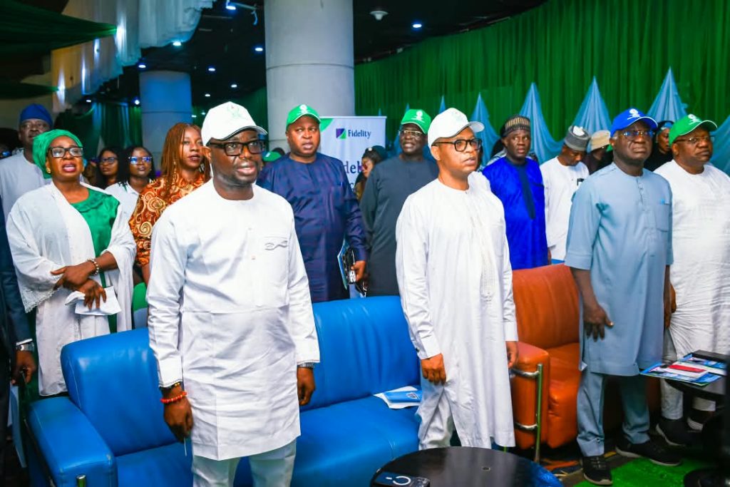 L-R: The honourable minister of Humanitarian Affairs and poverty reduction, Dr. Bernard M.  Doro, the permanent secretary in the ministry, Mr Olubunmi Olusanya and other dignitaries reciting the national anthem at the take off of the event in Abuja.
