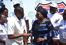 Ag. National Coordinator/CEO of the SERVICOM Office, Mrs. Helen Lawal in a ward handshake with the Registrar and Chief Executive of JAMB, Professor Segun Aina after his decoration as SERVICOM Champion during the Board’s commemoration of the 2026 Customer Service Week on 19th October, 2026 at the Headquarters of Joint Admissions and Matriculation Board (JAMB) in Abuja.