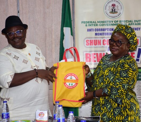 SERVICOM Head of Operations, Mrs. Ngozi Akinbodewa, presenting some Awareness Materials to the Permanent Secretary, Federal Ministry of Special Duties and Intergovernmental Affairs, Dr. Onwusoro Maduka I., during the inauguration of the newly appointed Ministerial SERVICOM Committee (MSC) members and the Permanent Secretary’s decoration as SERVICOM Champion at the Ministry’s Headquarters in Abuja on 29th October, 2026.